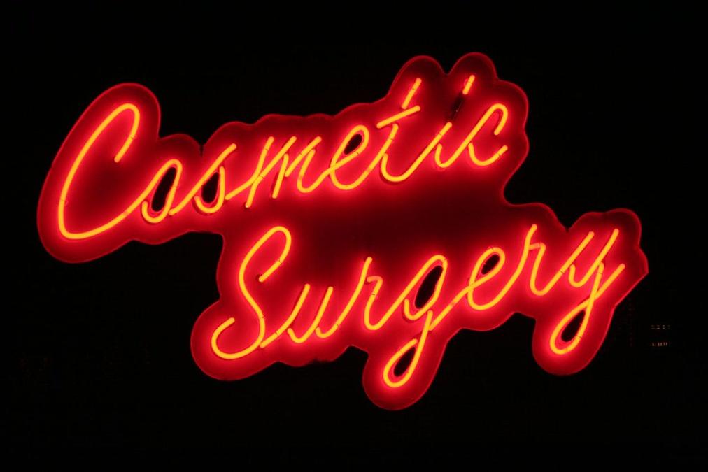 Cosmetic Surgery - a neon sign that says conta sury